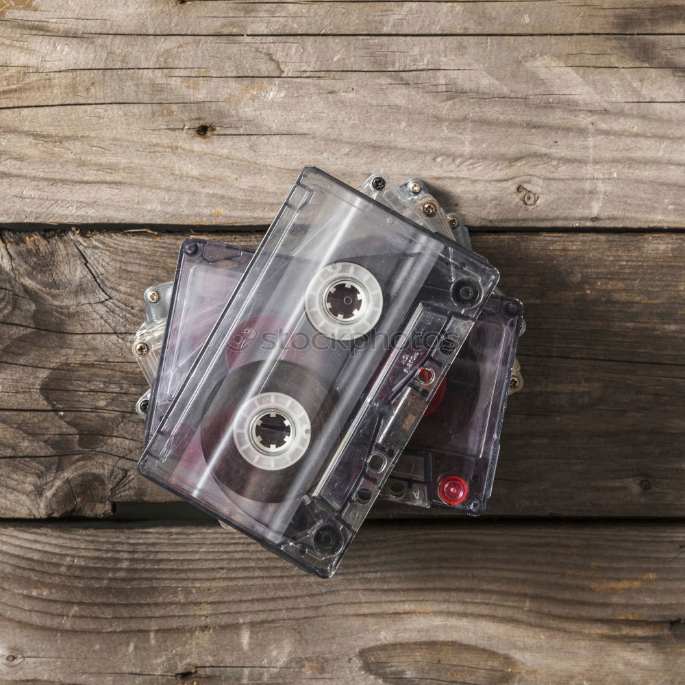 Similar – Image, Stock Photo Hand holds a music cassette from the 90s in the air