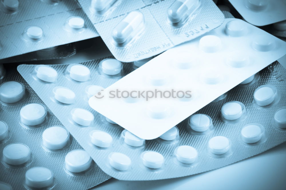 Similar – pill bottle,blister with white tablets,painkillers and a glass of water.Concept of medicine