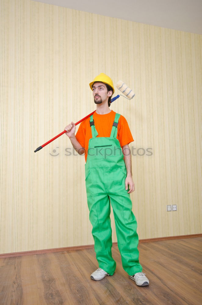 Similar – A househusband in pink slippers and cleaning utensils