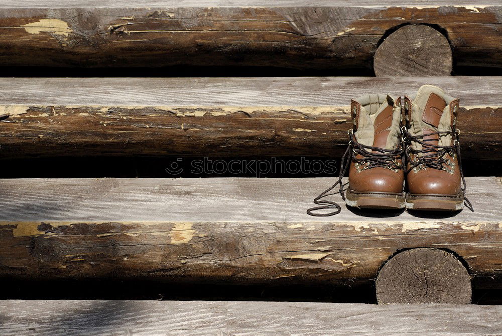 Similar – Blue jeans, boots with wooden smoking pipe