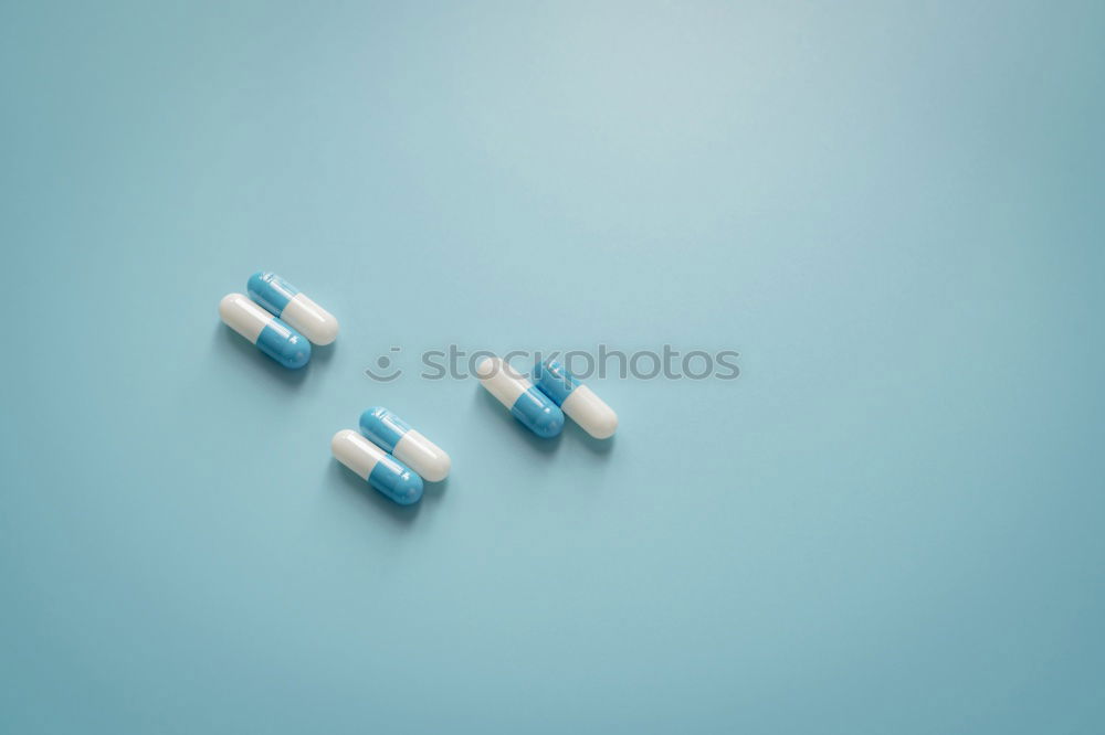 Similar – Image, Stock Photo Two capsule-shaped red and white pills made of paper