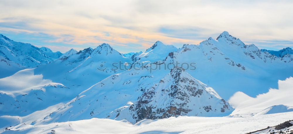 Similar – Snowy blue mountains in clouds at sunset