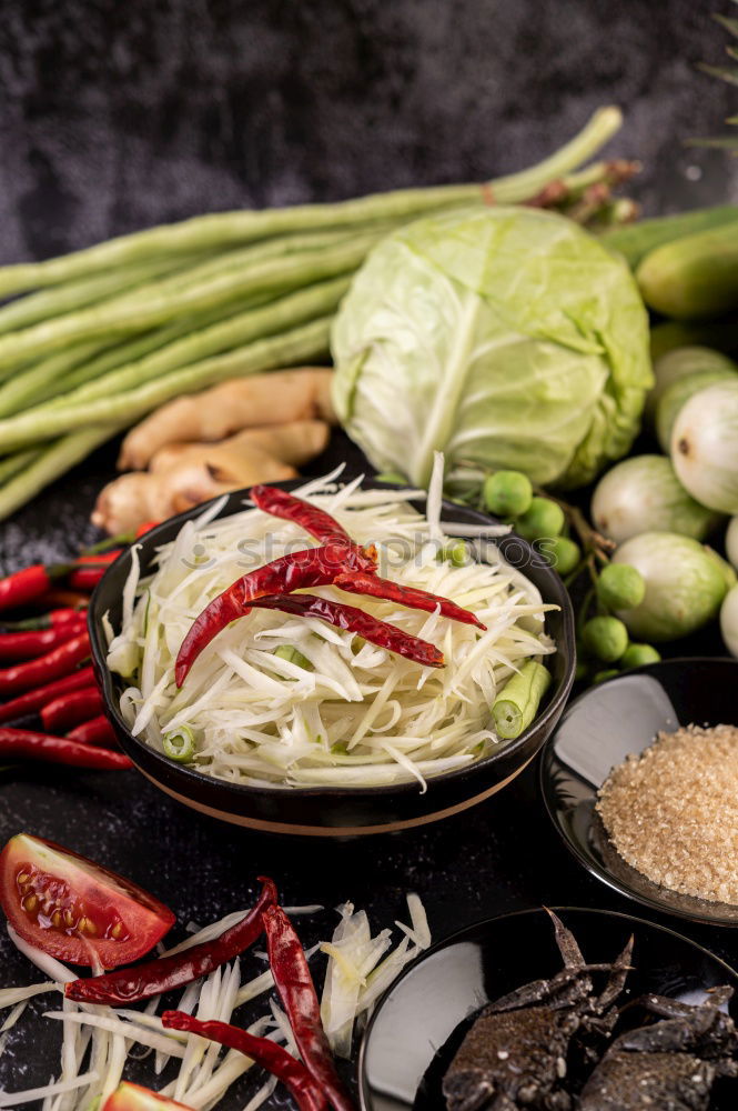 Similar – Healthy green salad with dressing on dark background