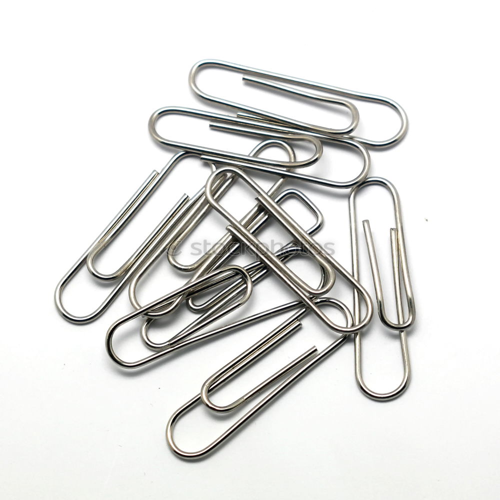 many paperclips on yellow background