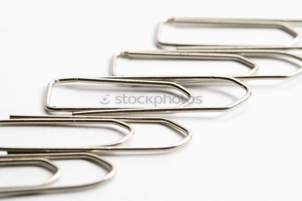 Similar – many paperclips on yellow background