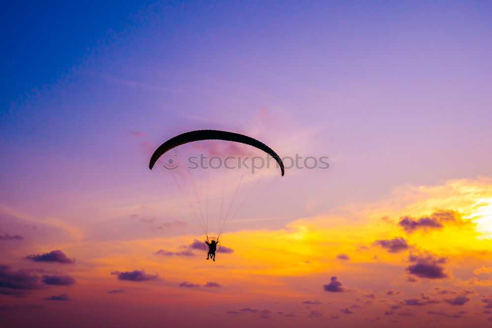 Similar – Image, Stock Photo Paragliding in the sunset at the sea