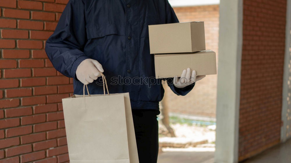 Similar – Foto Bild Eine junge Frau öffnet neugierig und voller Vorfreude ein Paket