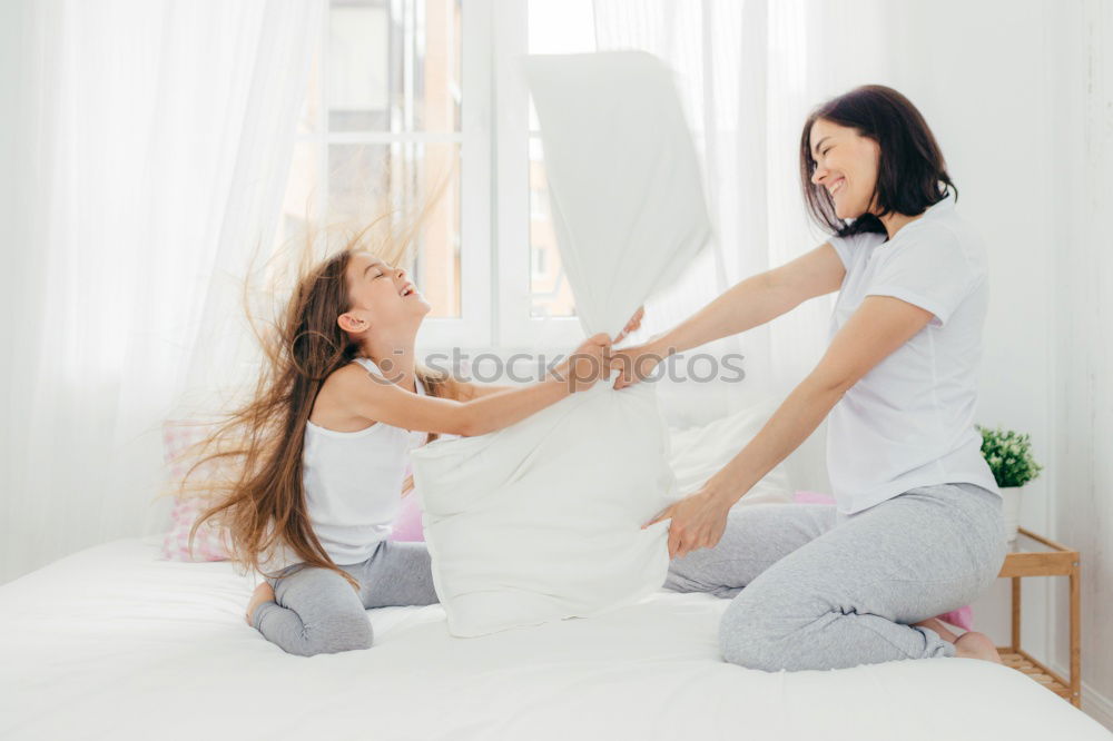 Similar – happy mother and child son fooling and playing in bed