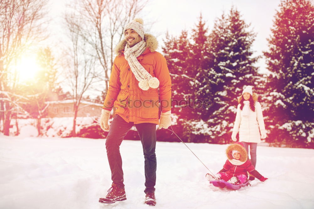 Similar – Teenage girl pulling sled with her little sister through forest