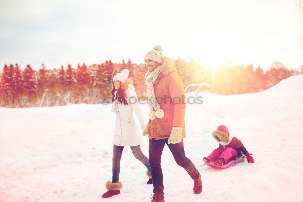 Similar – Teenage girl pulling sled with her little sister through forest