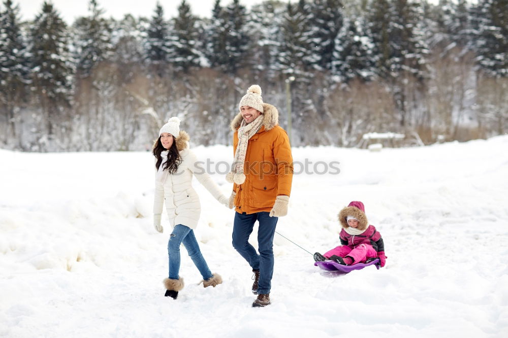 Similar – Teenage girl pulling sled with her little sister through forest