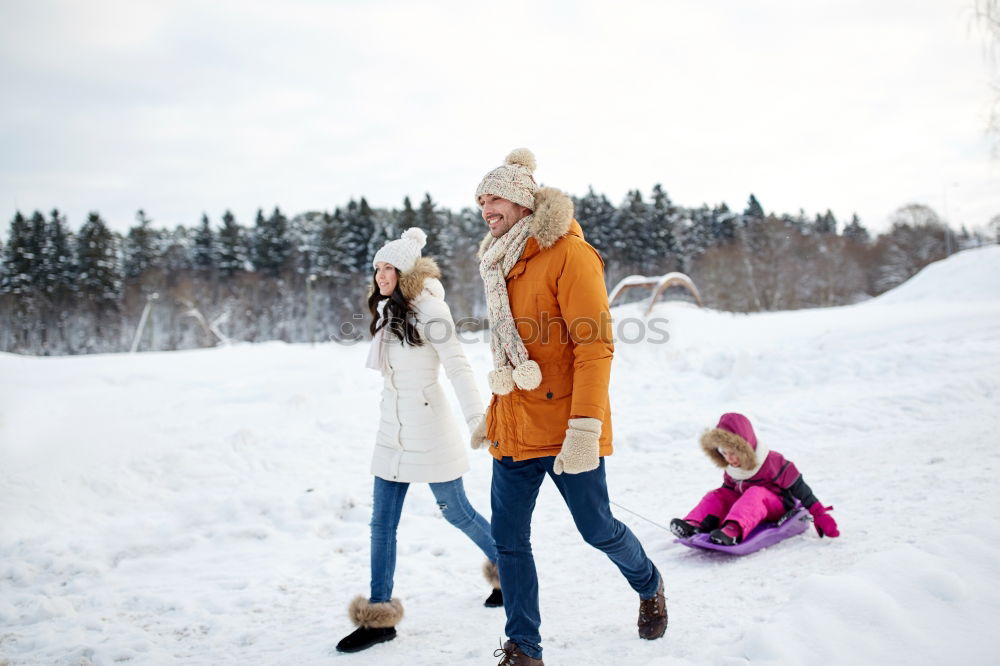 Similar – Teenage girl pulling sled with her little sister through forest