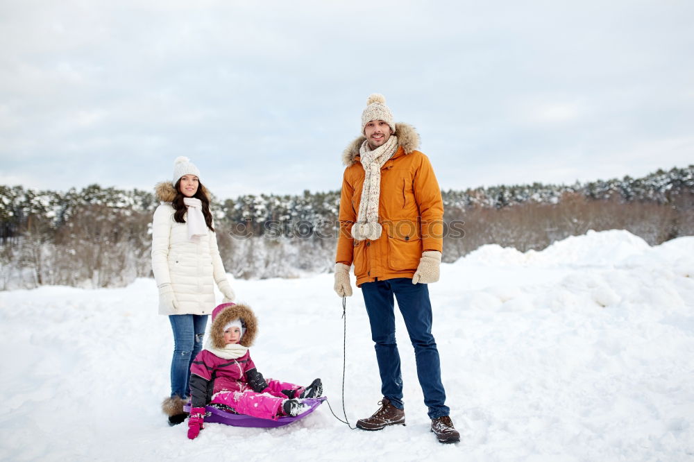 Similar – Teenage girl pulling sled with her little sister through forest