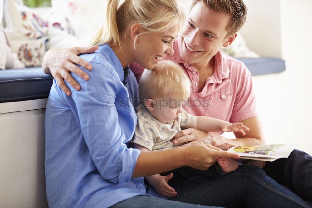 Similar – Mom reading a book her little daughter