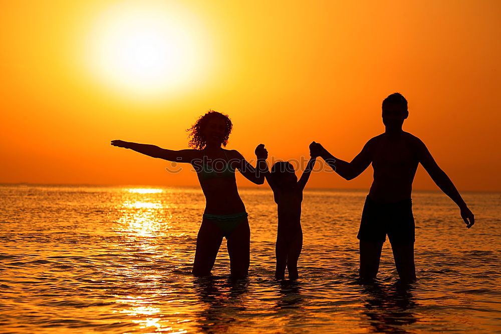 Similar – Father and son playing on the beach at the sunset time.