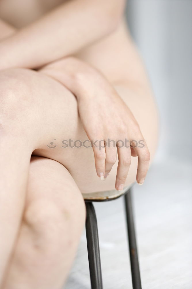 Similar – Above shot of white woman holding her legs in shoes