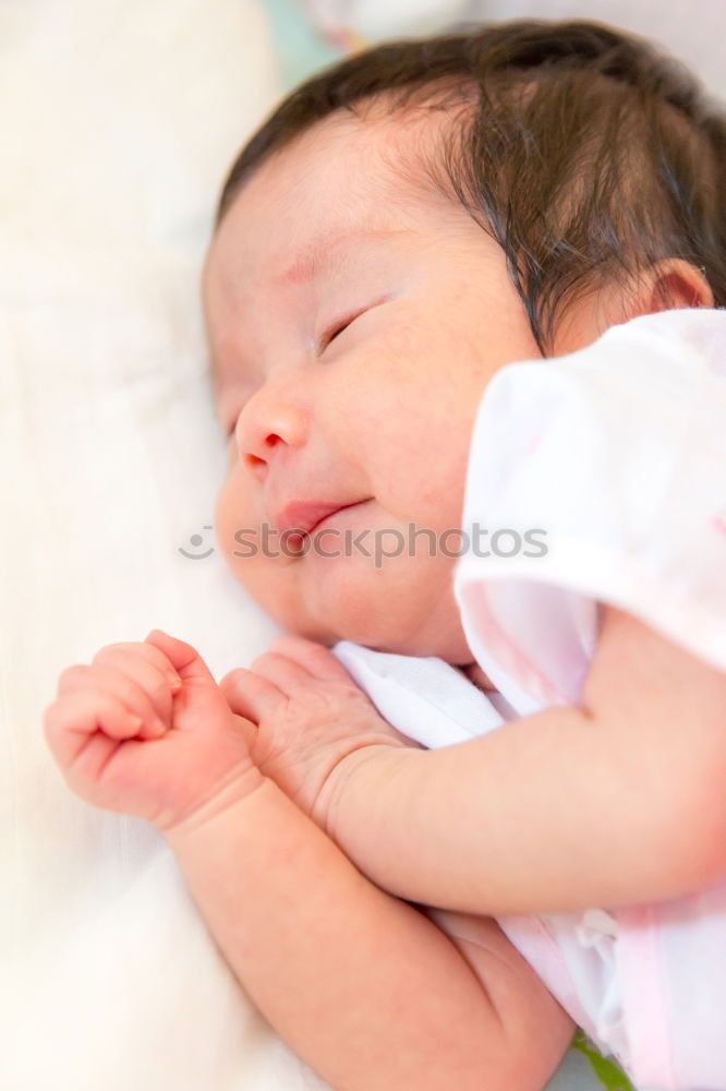 Similar – baby sleeping on his mother’s shoulder