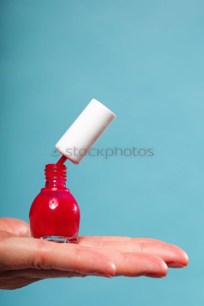 Similar – Female hand with red painted fingernails holding a bottle of red nail polish