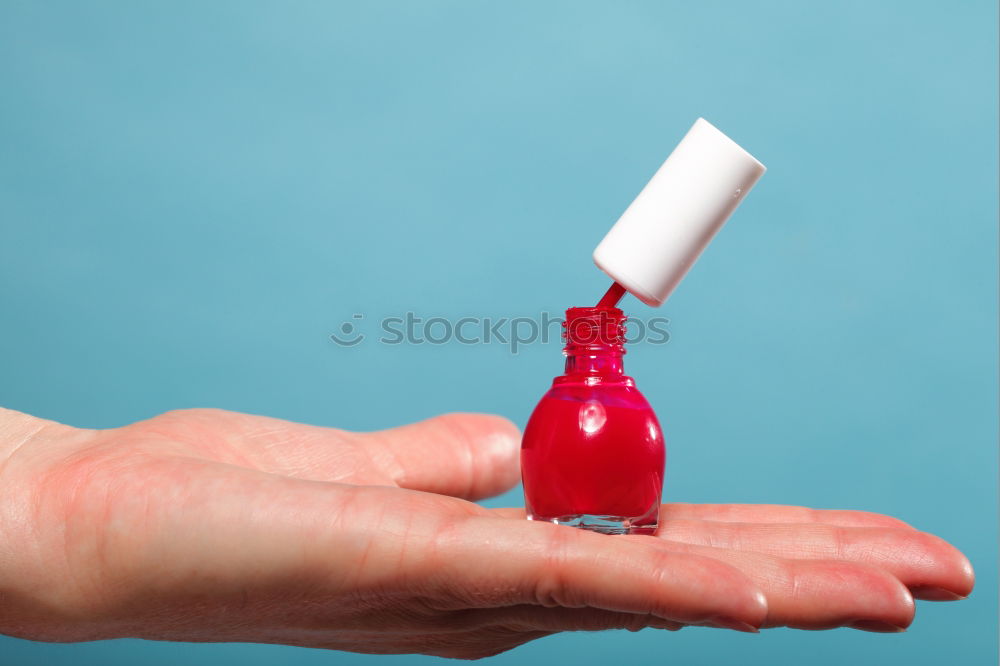 Similar – Female hand with red painted fingernails holding a bottle of red nail polish