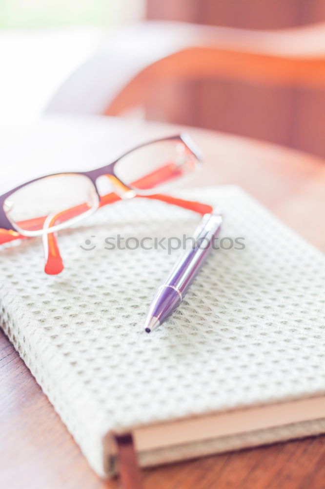 Similar – workplace with notepad, glasses, watch, pen