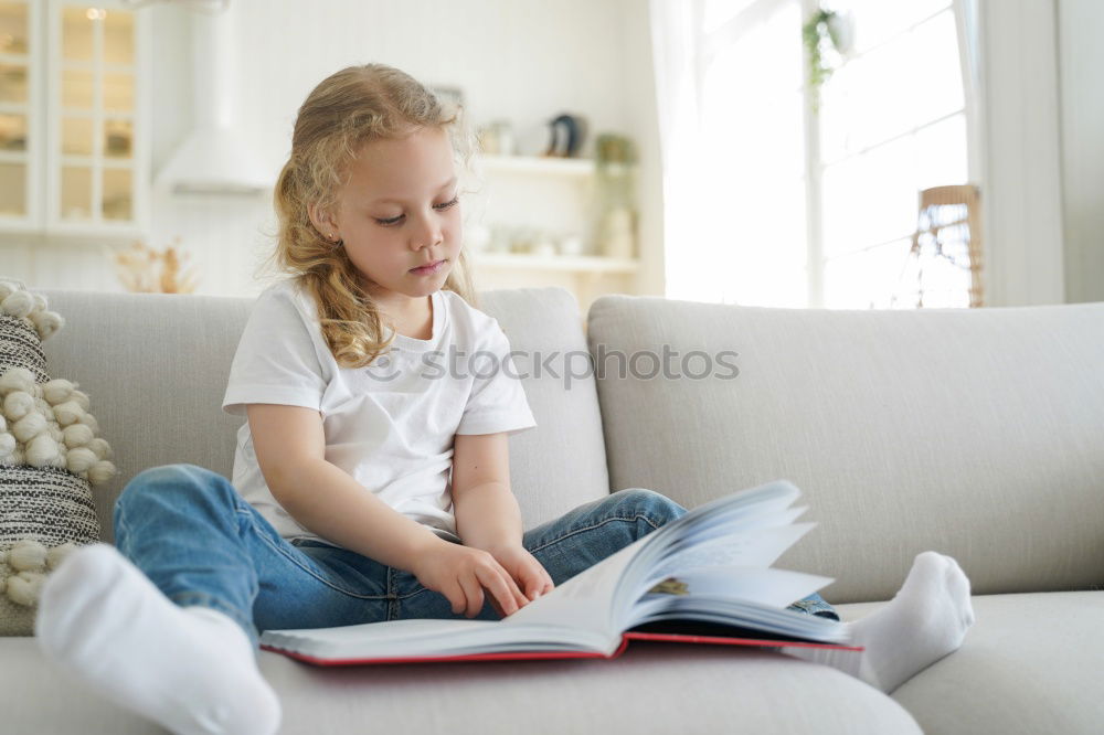 Similar – Image, Stock Photo Girl disguised as a butterfly reading with her doll