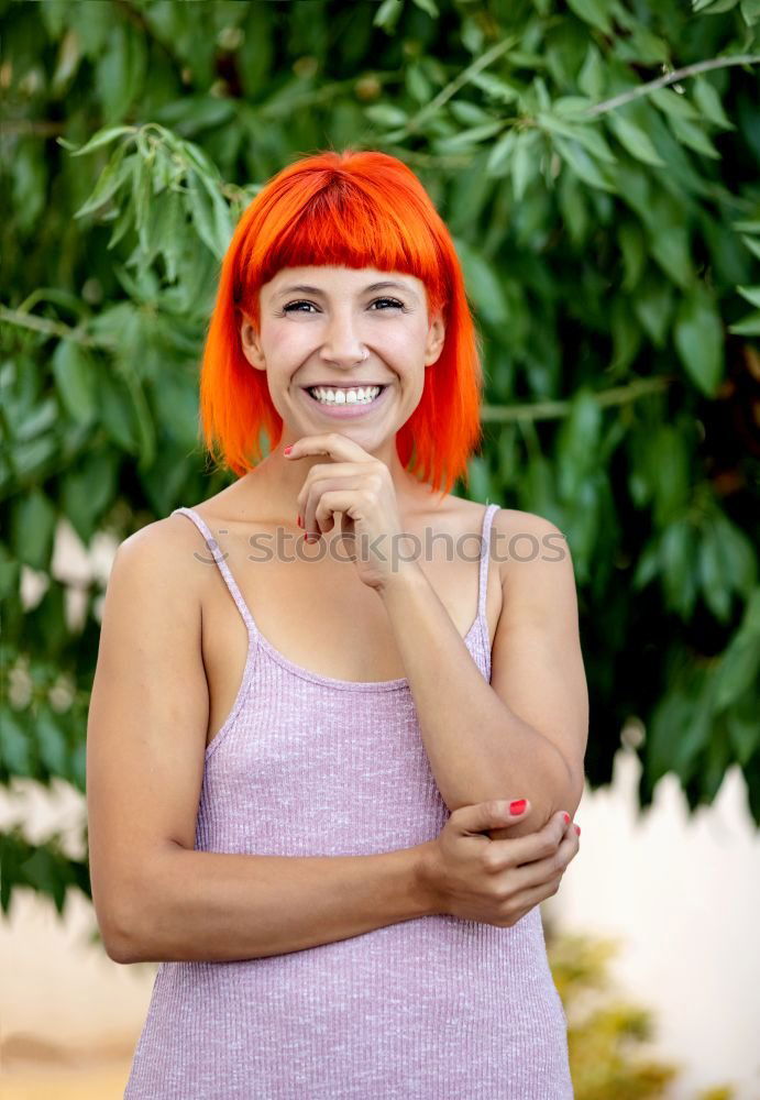 Similar – Redhead woman smelling a flower in a park