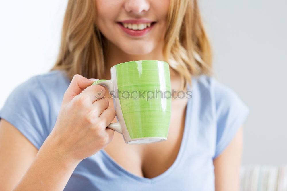 Similar – Happy young woman holding a cup of tea or coffee