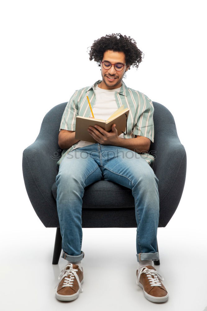 Portrait of a young thoughtful mixed race man sitting in the sofa