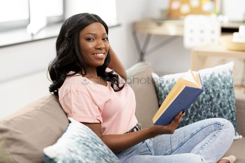 Similar – black woman reading on a sofa