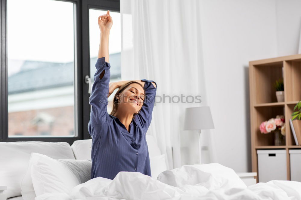 happy sleepy kid girl stretching in her room