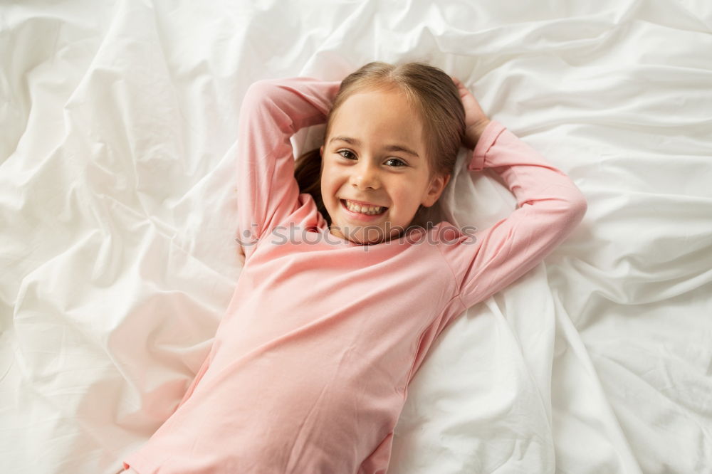 Similar – cute happy child girl relaxing at home on the bed