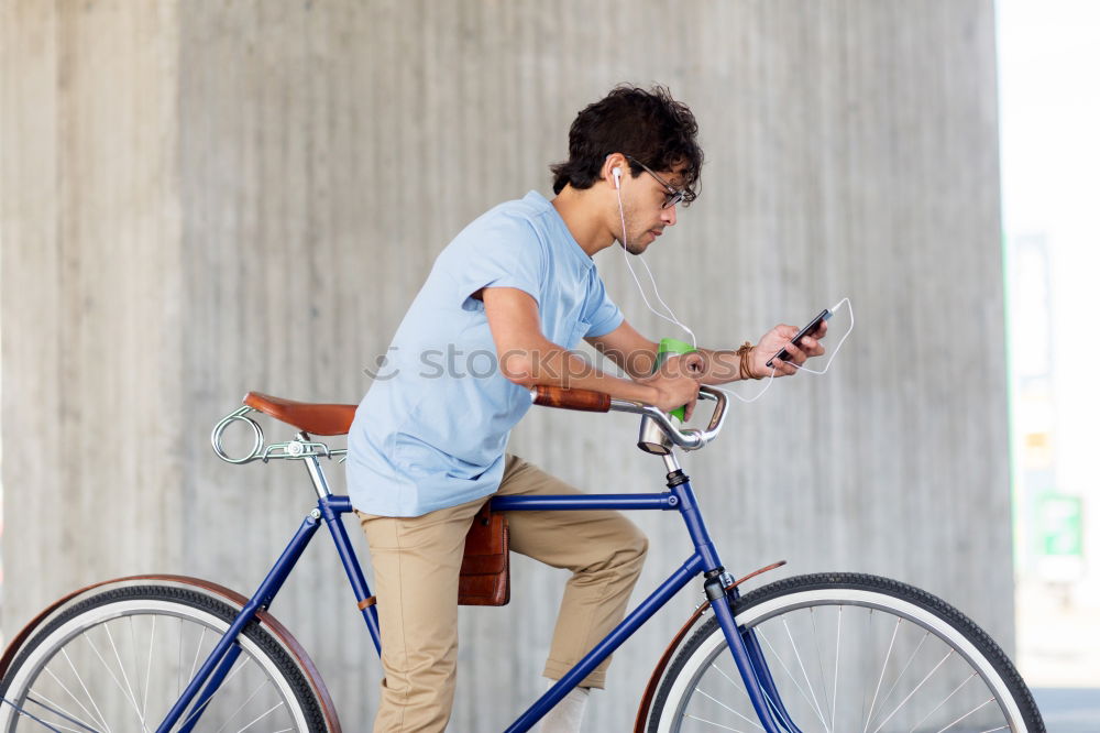 Similar – A young stylish man posing next to his bicycle.