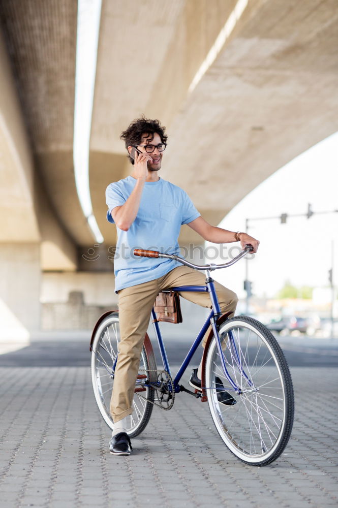 Similar – Handsome afro man walking with his bike.