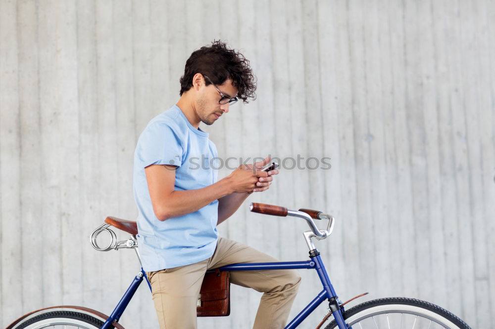 Similar – Image, Stock Photo Young man with mobile phone and fixed gear bicycle.