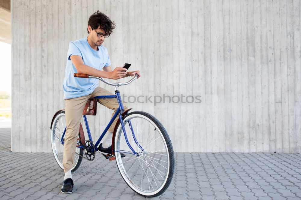 Similar – Image, Stock Photo Young man with mobile phone and fixed gear bicycle.