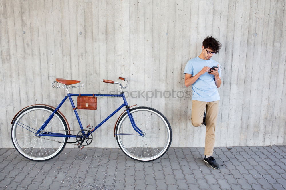 Image, Stock Photo Young man with mobile phone and fixed gear bicycle.