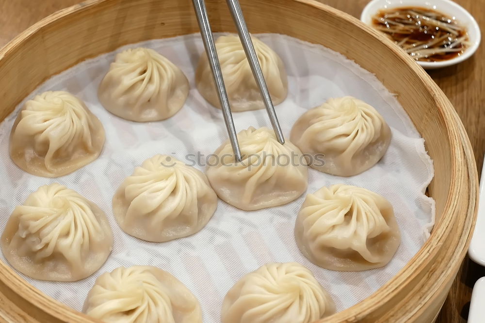 Similar – Dumplings or gyoza served in traditional steamer