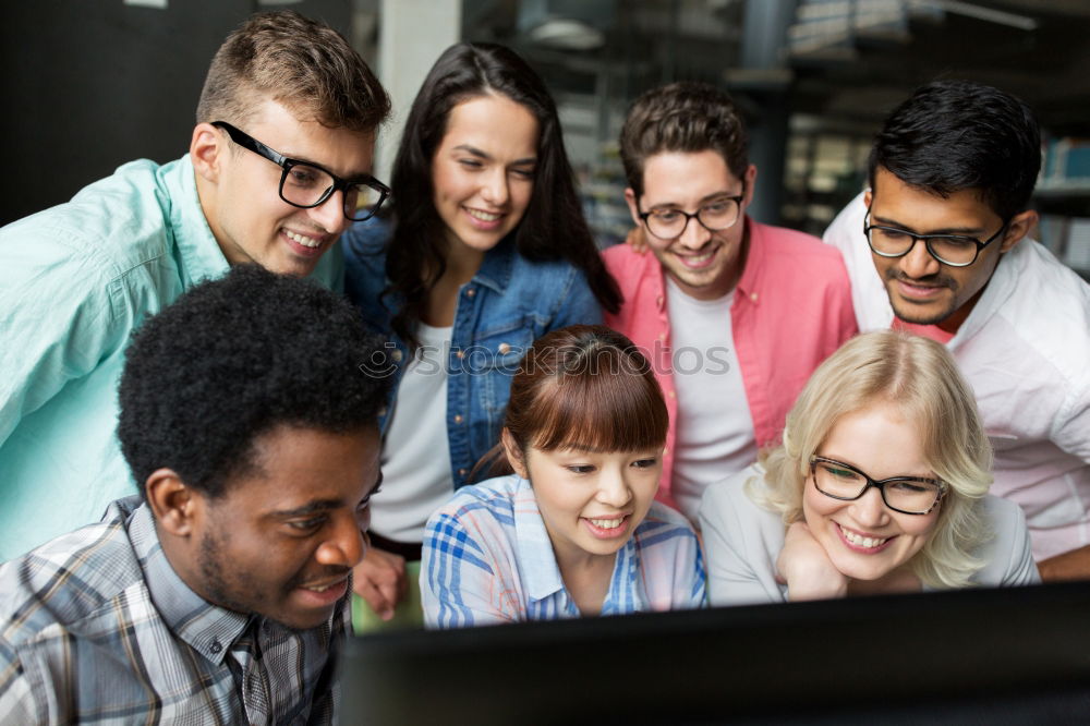 Image, Stock Photo Multiracial young people looking at a tablet computer