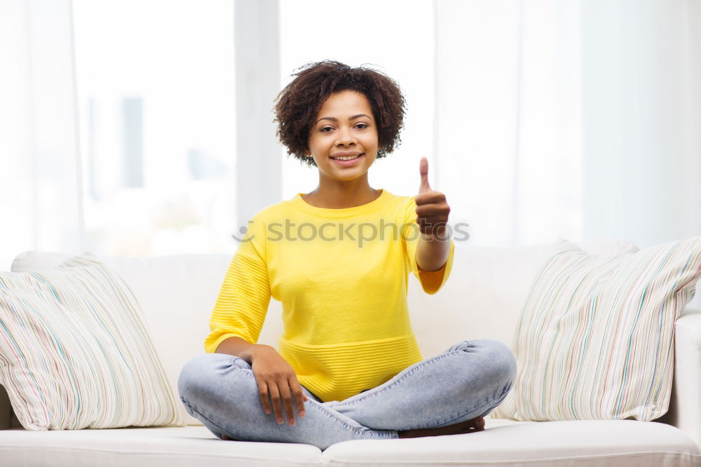 Similar – black woman reading on a sofa