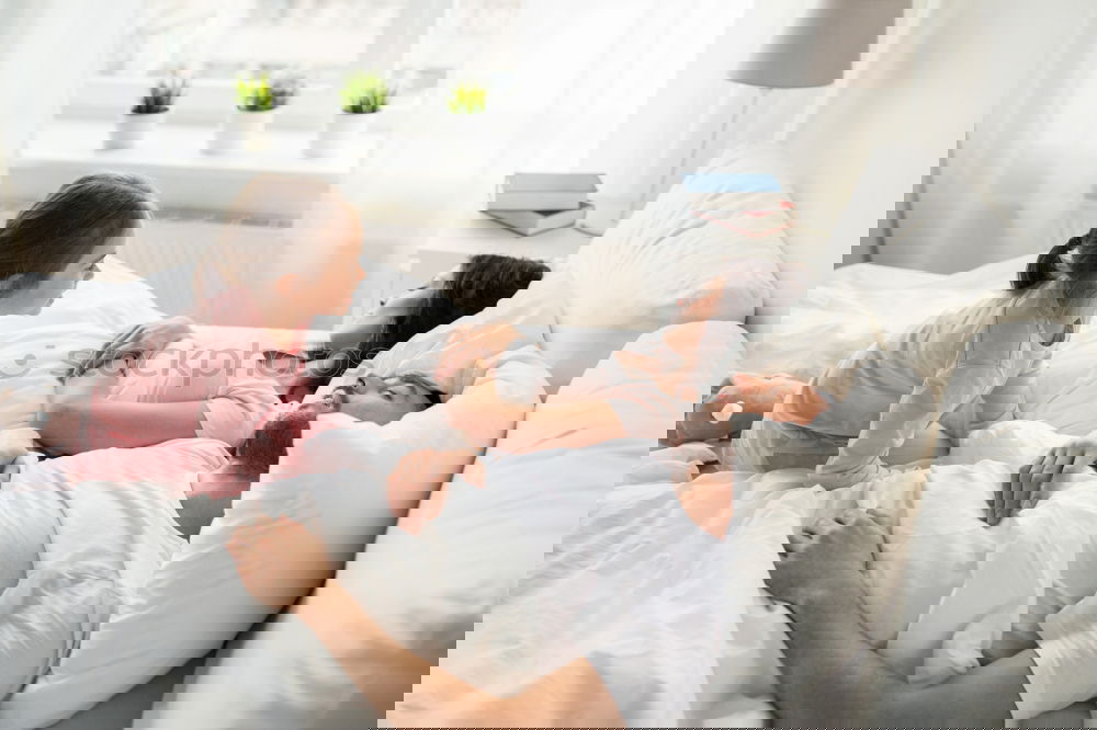 Similar – Image, Stock Photo mother kisses her toddler son in bed for good night
