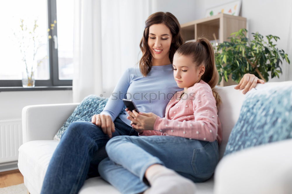 Similar – Image, Stock Photo Girl and boy reading a book sitting on the bed