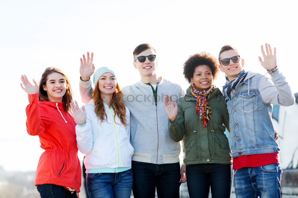 Similar – Group of multi-ethnic young people having fun together outdoors in urban background