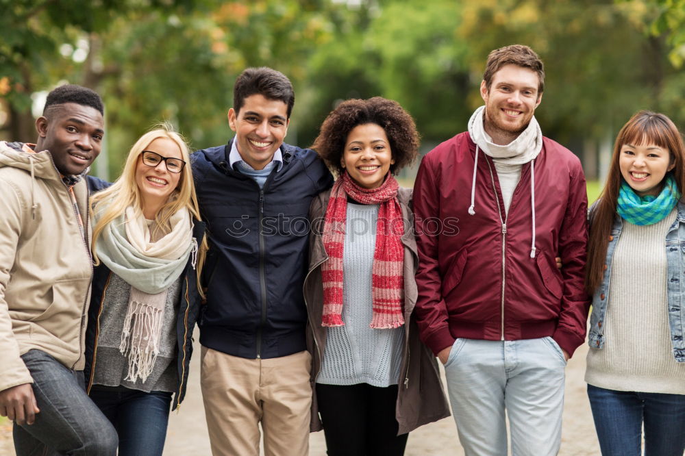 Similar – Group of multi-ethnic young people laughing together outdoors in urban background.