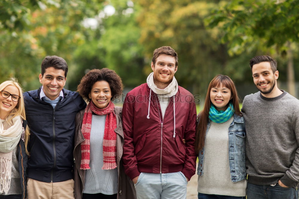 Similar – Group of multi-ethnic young people laughing together outdoors in urban background.