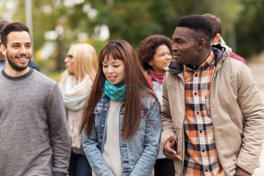 Similar – Multiracial group of three friends having a coffee together