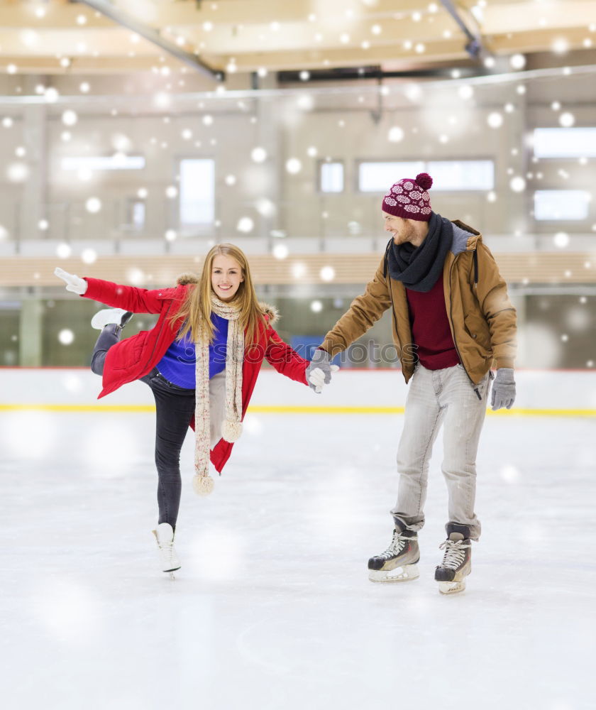 Lovely couple standing in the center of the rink