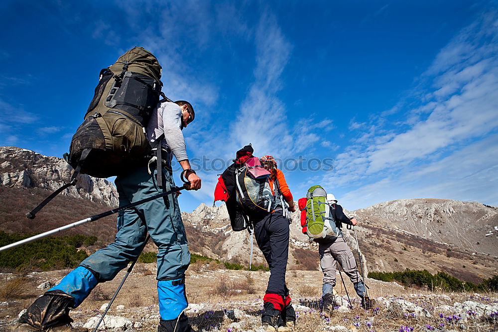 Four people with hiking backpacks, mountain landscape, Scandinavia