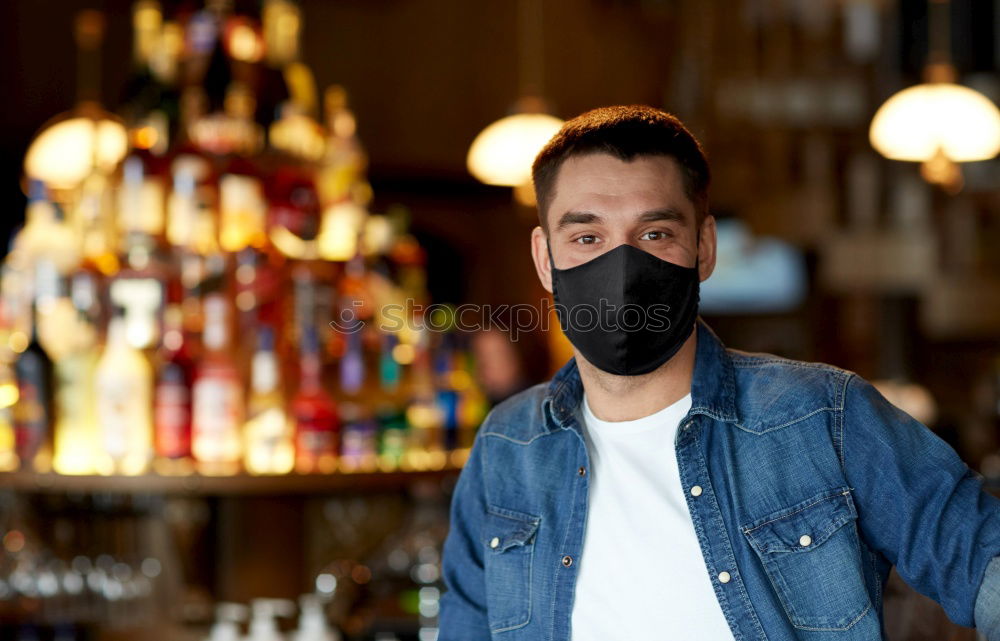 Similar – Young man standing in the city center wearing the face mask to avoid virus infection