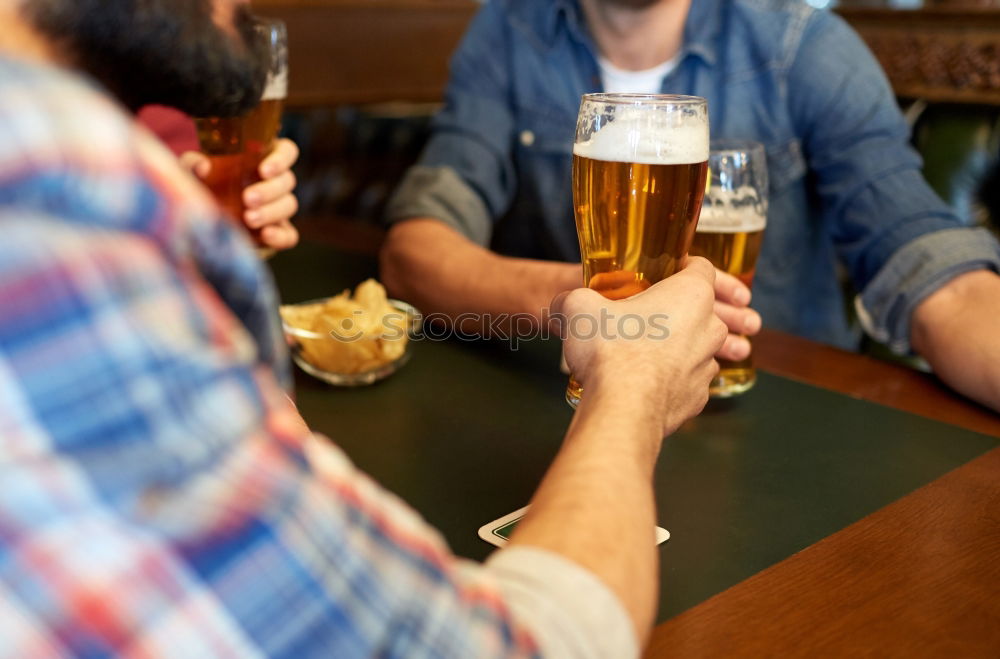 Similar – On a table there is a bottle of alcohol and a shot glass. A person’s hand is holding the shot glass.