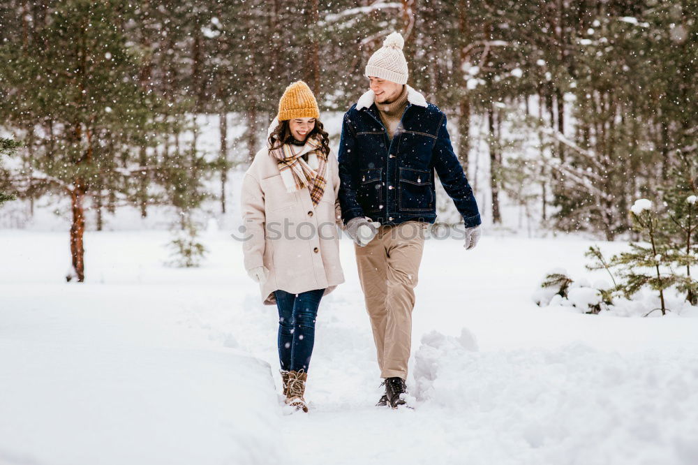 Similar – Lifestyle winter portrait of romantic couple walking